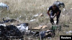 A member of a group of international experts inspecting the site where the downed Malaysia Airlines Flight 17 crashed, near the village of Hrabove in the Donetsk region of eastern Ukraine, in mid-July.