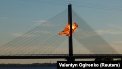 A Russian jet-powered drone strikes a bridge spanning the Dnieper River in Kyiv on October 2.