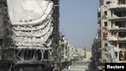 Buildings damaged by fighting, according to the opposition, are seen in Homs on April 10.