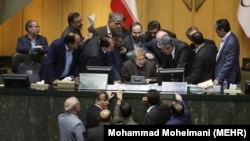 Iranian parliament speaker Ali Larijani, seated at center, talks with a group of lawmakers in a session of parliament in Tehran, Iran, on Dec 02, 2018.