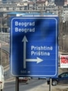 Kosovo - A board reading "Independence" is seen behind a road sign the entrance of Pristina on February 15, 2008.