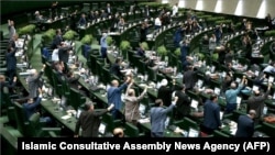 IRAN -- Iranian MPs chant anti U.S. slogans at the parliament in Tehran, May 9, 2018