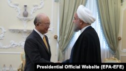 IRAN -- A handout photo made available by the presidential official website shows, Iranian President Hassan Rouhani (R) greeting Director General of the International Atomic Energy Agency (IAEA) Yukiya Amano (L), at the presidential office in Tehran, Ira