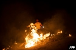 A demonstrator clashes with riot police in Istanbul's Gazi neighborhood on the evening of June 8.