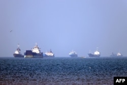 Shipping vessels lie anchored in the Strait of Hormuz in May 4.
