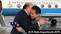 File photos:US Ambassador to Switzerland Edward T. McMullen, Jr. welcomes Princeton graduate student Xiyue Wang on arrival in Switzerland after his release from Iran on December 7.