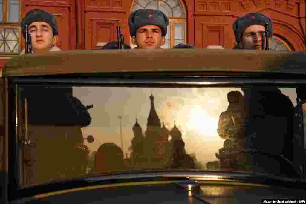 Russian soldiers dressed in Red Army World War II uniforms sit in the back of a truck as St. Basil&#39;s Cathedral is reflected in the windshield prior to the start of a parade in Red Square in Moscow. (AP/Alexander Zemlianichenko)