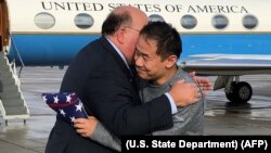 U.S. Ambassador to Switzerland Edward T. McMullen, Jr. (left) welcomes Xiyue Wang on arrival in Switzerland after his release from Iranian captivity on December 7.