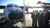 Russian President Vladimir Putin looks at a Let L-410 UVP-E20 Turbolet transport aircraft during a visit to Patriot military park outside Moscow in 2018. 