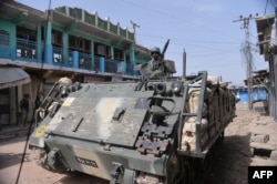 Pakistani soldiers patrol with an armoured vehicle in Miran Shah.