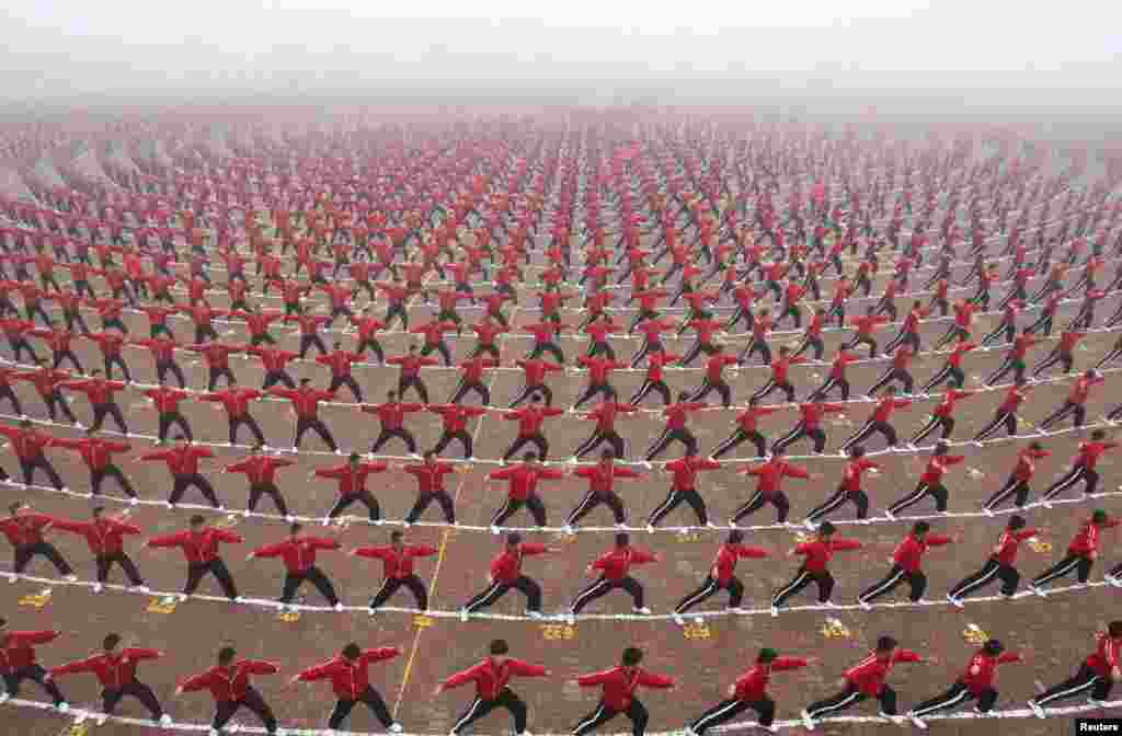 Chinese students perform during a founding ceremony of a soccer team of Shaolin Tagou martial arts school in Dengfeng, Henan Province. (Reuters/China Daily)