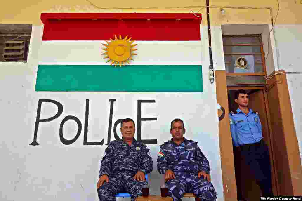 Local Kurdish police keep an eye on the camp. One of the cells has been converted into a police station.