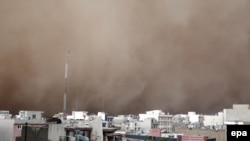 A dust storm engulfs Tehran on June 2. The storm killed five people, injured several dozen more, and knocked out power to around 50,000 homes in the Iranian capital.
