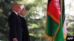 Visiting Afghan President Ashraf Ghani (left) and Iranian President Hassan Rohani at a welcoming ceremony in Tehran on April 19