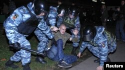 Russian police detain a man after a nationalism-fueled protest in the Biryulyovo district of Moscow in October.