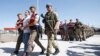 Soldiers who are charged with participating in the 2016 attempted coup in Turkey are accompanied by Turkish soldiers as they arrive at the court outside Ankara on August 1.