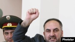 Armenia -- Miasnik Malkhasian, one of the arrested Armenian opposition figures, greets supporters attending his trial on June 16, 2009.