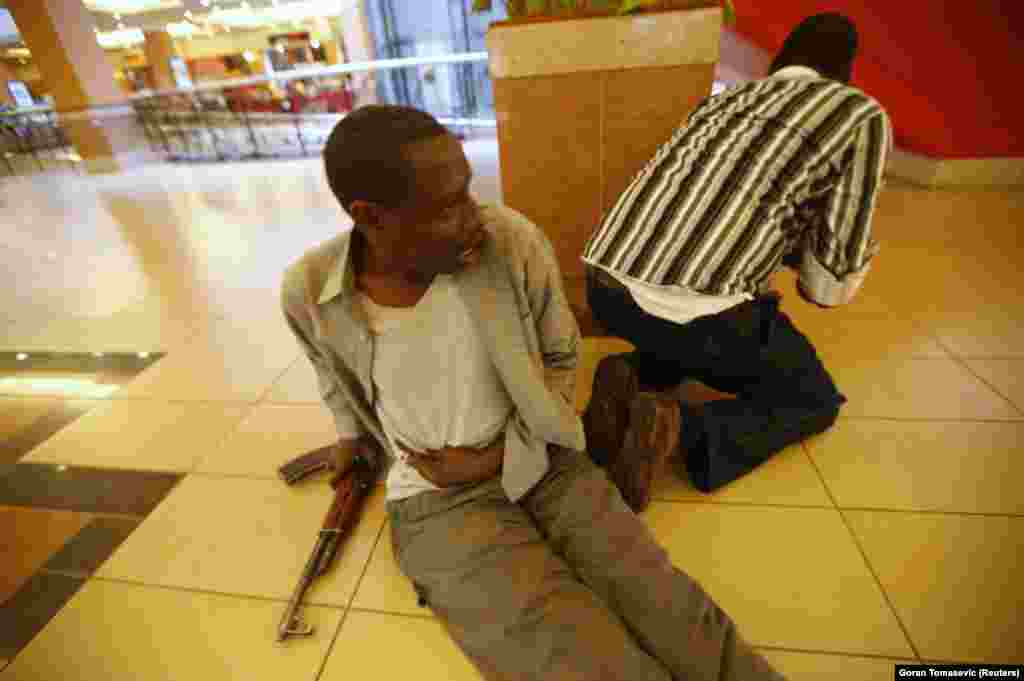 A Kenyan policemen after being shot by an attacker inside the mall. The man described watching his intestines bubbling out of the wound. After taking this picture, Tomasevic helped the man to safety. &quot;I was running with him,&quot; the photographer recalled in a documentary on the attack. &quot;He started firing his AK by accident between our legs, so it was a little difficult, you know.&quot;