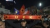 People celebrate in Pristina after parliament passed legislation limiting the decisions of a Hague-based war crimes court on October 6. The EU has expressed "deep concern" over the amendment.