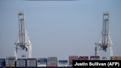 A Maersk Line container ship sits docked in a berth at the Port of Oakland on February 19, 2015 in Oakland, California.