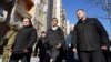 U.K. Prime Minister Rishi Sunak (center) is escorted during a tour of damaged buildings in Kyiv upon his arrival to Ukraine on January 12.