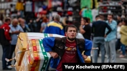 RUSSIA -- Migrant laborers work in a market in Moscow, June 29, 2021