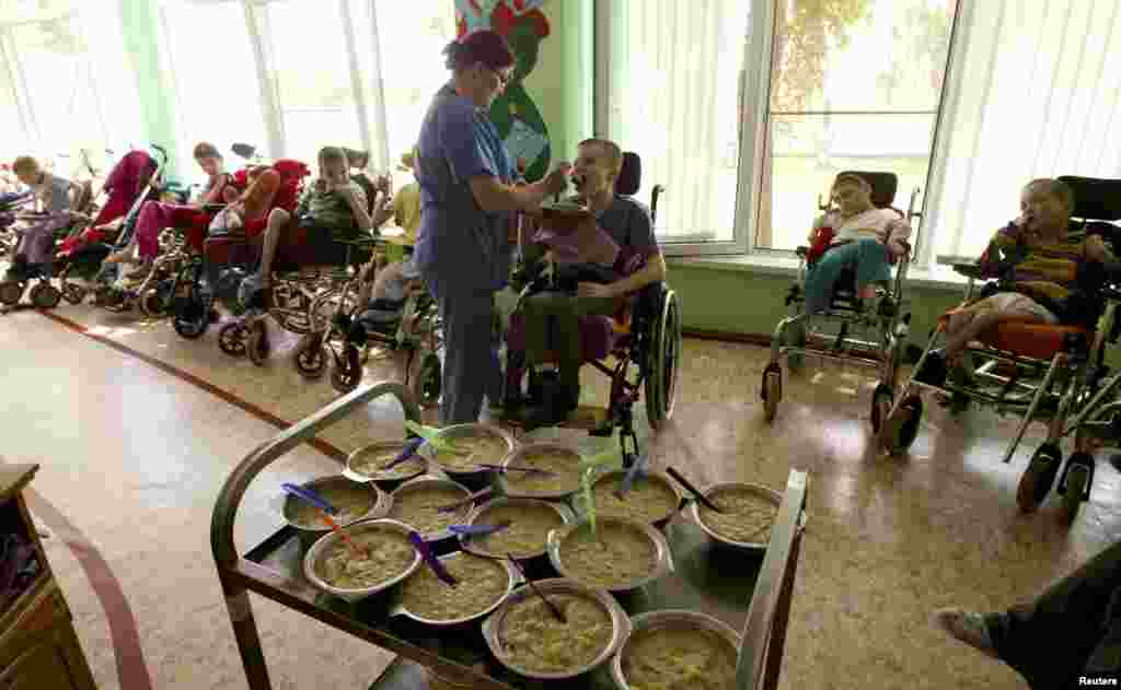 Nurse Lubov Tagai feeds one of the children.