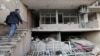 An Iranian man in Tehran goes into his house, which was badly damaged in an air strike on March 14. 