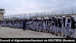 Newly freed Taliban prisoners line up at Bagram prison, north of Kabul, Afghanistan April 11, 2020. Picture taken April 11, 2020. 