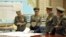 North Korean leader Kim Jong Un (seated) is seen in an official handout photo reportedly discussing a strike plan with North Korean officers during an urgent operation meeting at the Supreme Command in an undisclosed location.