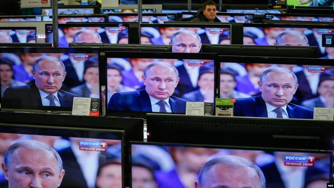 TV screens showing Russian President Vladimir Putin during an annual nationwide Q&A on April 16.