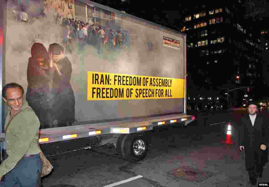 A truck in New York bears a poster challenging alleged official abuses since Iran's disputed election in June.