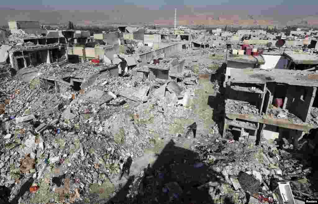 A man passes by buildings destroyed by Syrian Air Force strikes in the Duma neighborhood of Damascus. (Reuters/Goran Tomasevic)