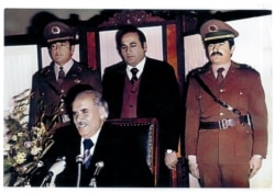 Then-Interior Minister Faqir Mohammad Faqir (center) stands next to army chief Yaqub Khan, with then-President Nur Mohammad Taraki seated in front.