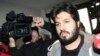 Reza Zarrab, a dual citizen of Turkey and his native Iran, is surrounded by journalists as he arrives at a police center in Istanbul in December 2013. Will his U.S. trial expose facts Turkey's president would rather not be made public?