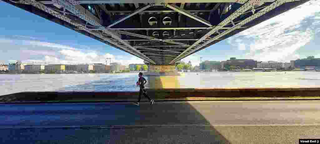 A user-generated photo captures a runner under a bridge in Budapest. &quot;Hungary has learned flood protection during the previous floods, and professionals and volunteers know exactly what to do,&quot; Orban said. &nbsp;