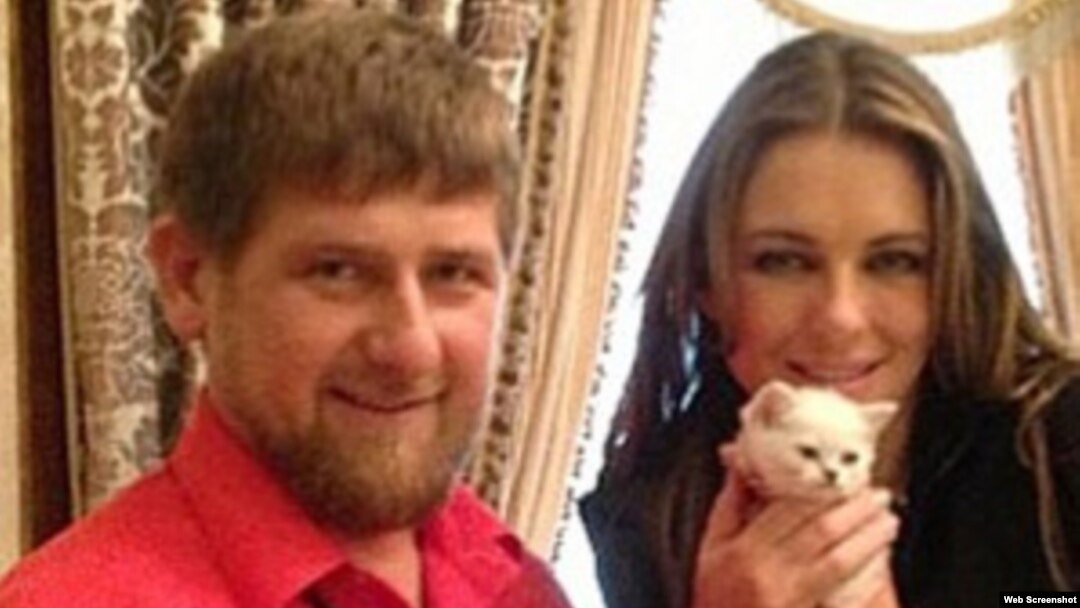 Chechen leader Ramzan Kadyrov (left) with actress Elizabeth Hurley and a white kitten in 2013. 