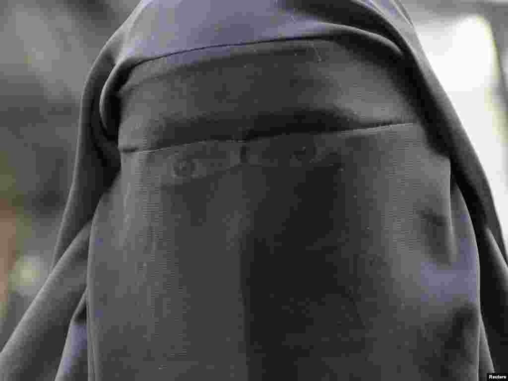 A woman who identified herself as Nayet, wearing a burqa, is seen after her release from a police station in Paris on April 11. France's ban on full face veils, a first in Europe, went into force, exposing anyone who wears the Muslim niqab or burqa in public to fines of 150 euros ($216) and lessons in French citizenship. Photo by Gonzalo Fuentes for Reuters