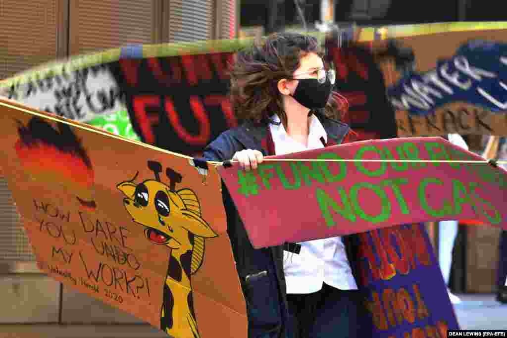 A person takes part in &#39;Fund Our Futures Not Gas&#39; climate rally in Sydney, Australia, September 25, 2020. In Australia, thousands of students took part in about 500 small gatherings and online protests, to demand investment in renewable energy and oppose funding for gas projects.