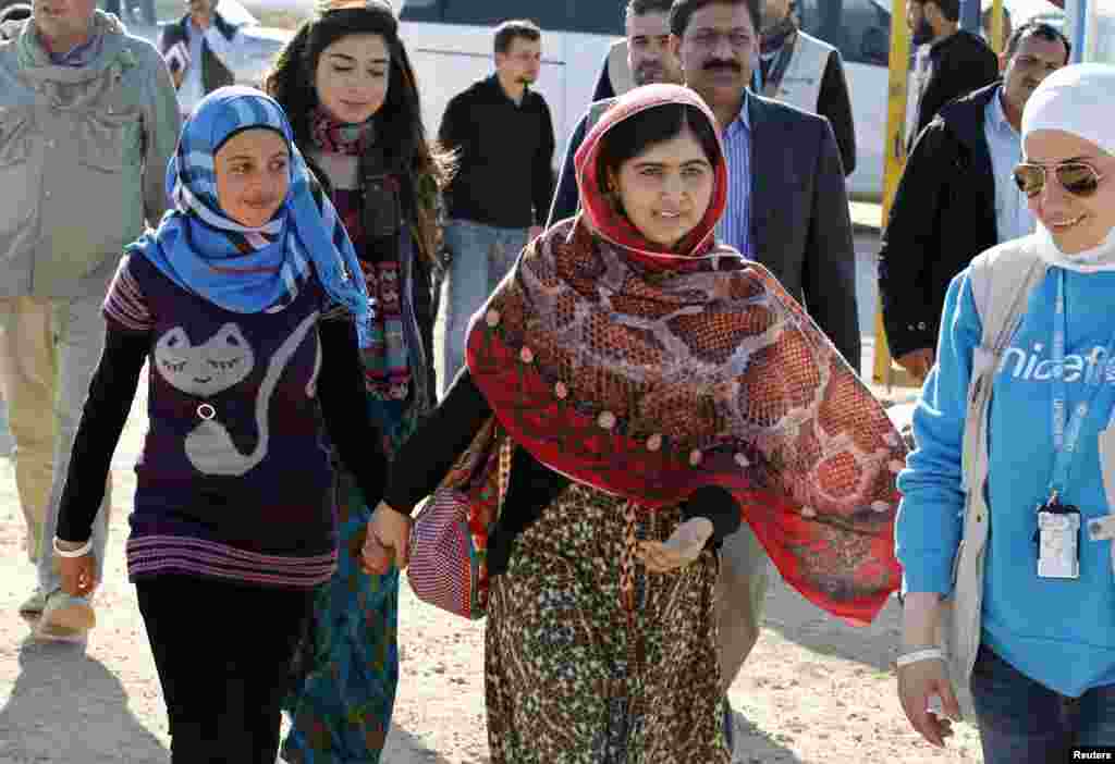 Yousafzai and Syrian refugee Mazoon Rakan (left) tour a UNICEF center to visit an art gallery for children at the Zaatri refugee camp in the Jordanian city of Mafraq on February 18, 2014.