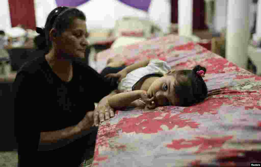 Displaced people from the minority Yazidi sect, who fled violence in the Iraqi province of Nineveh in northern Iraq, take shelter at Margurgis Church in Dohuk. (Reuters/Youssef Boudlal)