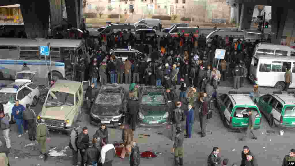 Onlookers gather at the site of a powerful explosion in the Midan neighborhood of Damascus, Syria. AFP PHOTO/HO/SANA
