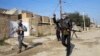 Gunmen walk in the streets of the Iraqi city of Ramadi, 100 kilometers west of Baghdad, in January.