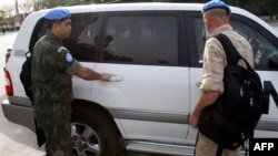 UN monitors arrive at a hotel in Damascus on April 18.