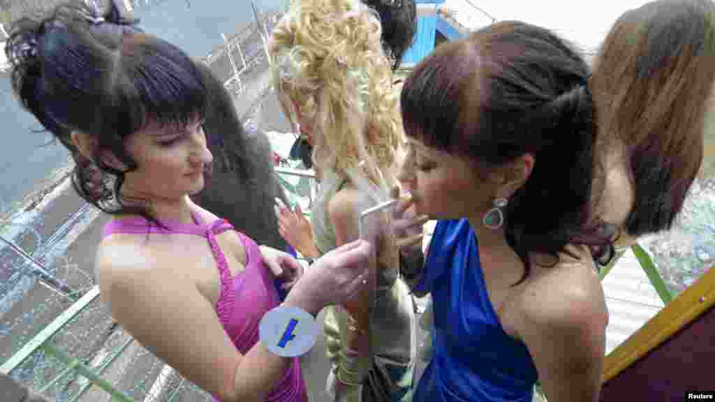 Inmates smoke as they take part in the Miss Spring 2012 beauty contest, held at the Russian women&#39;s penal colony No. 10, at the Gornyi settlement. (Reuters/Yuri Maltsev)
