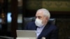 Iranian Foreign Minister Mohmmad Javad Zarif wears a protective mask and gloves as means of protection against the cornonavirus COVID-19, during a cabinet meeting in the capital Tehran, March 11, 2020