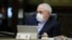 Iranian Foreign Minister Mohmmad Javad Zarif wears a protective mask and gloves as means of protection against the cornonavirus COVID-19, during a cabinet meeting in the capital Tehran, March 11, 202