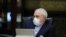 Iranian Foreign Minister Mohmmad Javad Zarif wears a protective mask and gloves as means of protection against the cornonavirus COVID-19, during a cabinet meeting in the capital Tehran, March 11, 2020