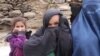 Saima (right), an Afghan widow, with her two daughters. Her husband was a Taliban fighter.