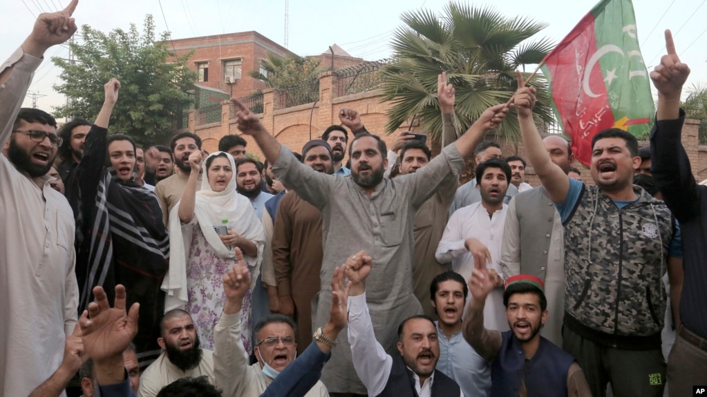 Supporters of Imran Khan's party chant anti government slogans in Peshawar on March 14 while protesting the police operation against the former Pakistani prime minister. 